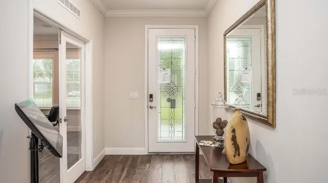 a view of a room with wooden floor and windows