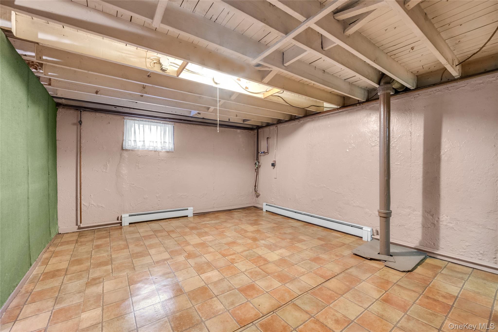 21 Farragut Road Old Bethpage, NY 11804 - Photo 19 of 22 Below grade area featuring a textured wall and a baseboard heating unit