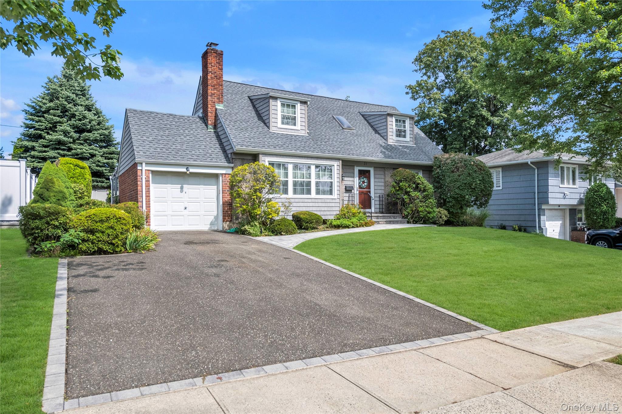 21 Farragut Road Old Bethpage, NY 11804 - Photo 22 of 22 Cape cod house with a front lawn, roof with shingles, a chimney, driveway, and an attached garage