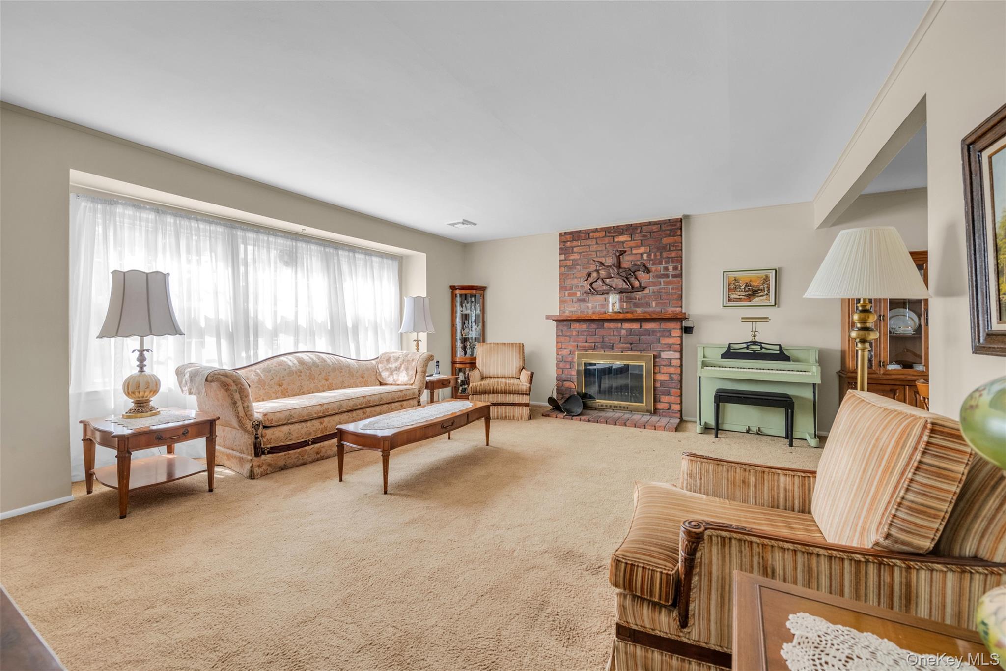 21 Farragut Road Old Bethpage, NY 11804 - Photo 3 of 22 Living area featuring carpet and a brick fireplace