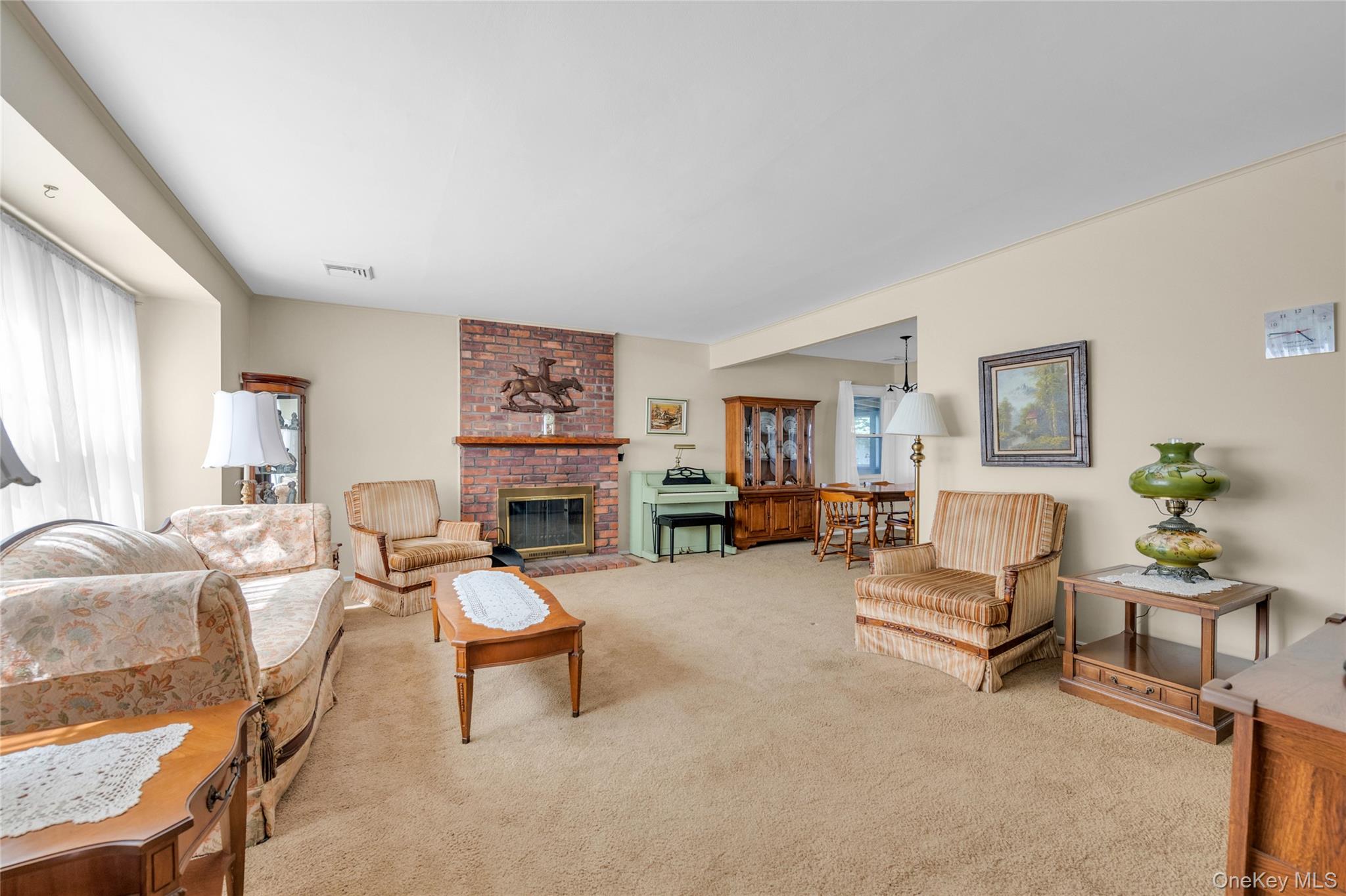 21 Farragut Road Old Bethpage, NY 11804 - Photo 4 of 22 Living room featuring light colored carpet and a fireplace