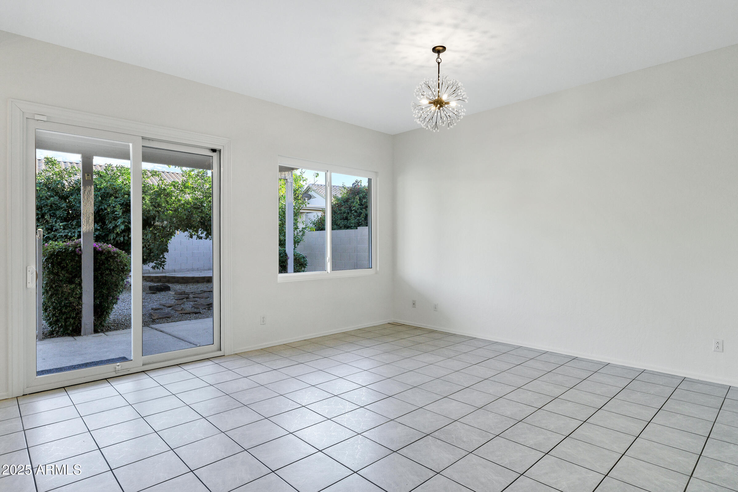1403 West Windhaven Avenue Gilbert, AZ 85233 - Photo 14 of 64 an empty room with windows and outdoor view