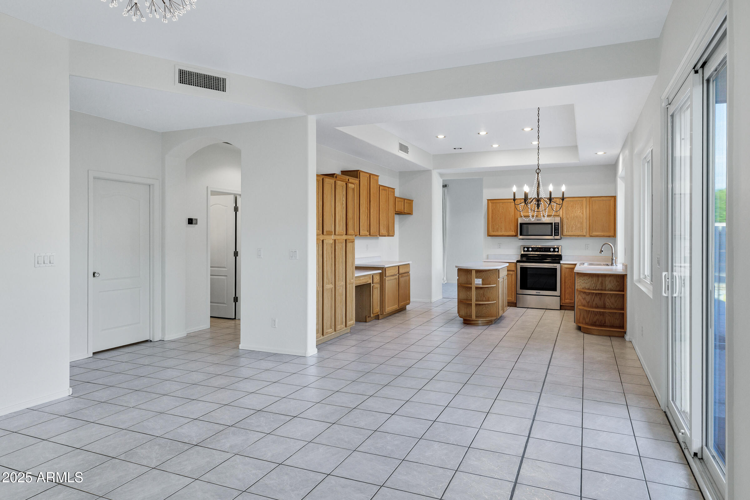 1403 West Windhaven Avenue Gilbert, AZ 85233 - Photo 16 of 64 a view of a kitchen with furniture and an empty room