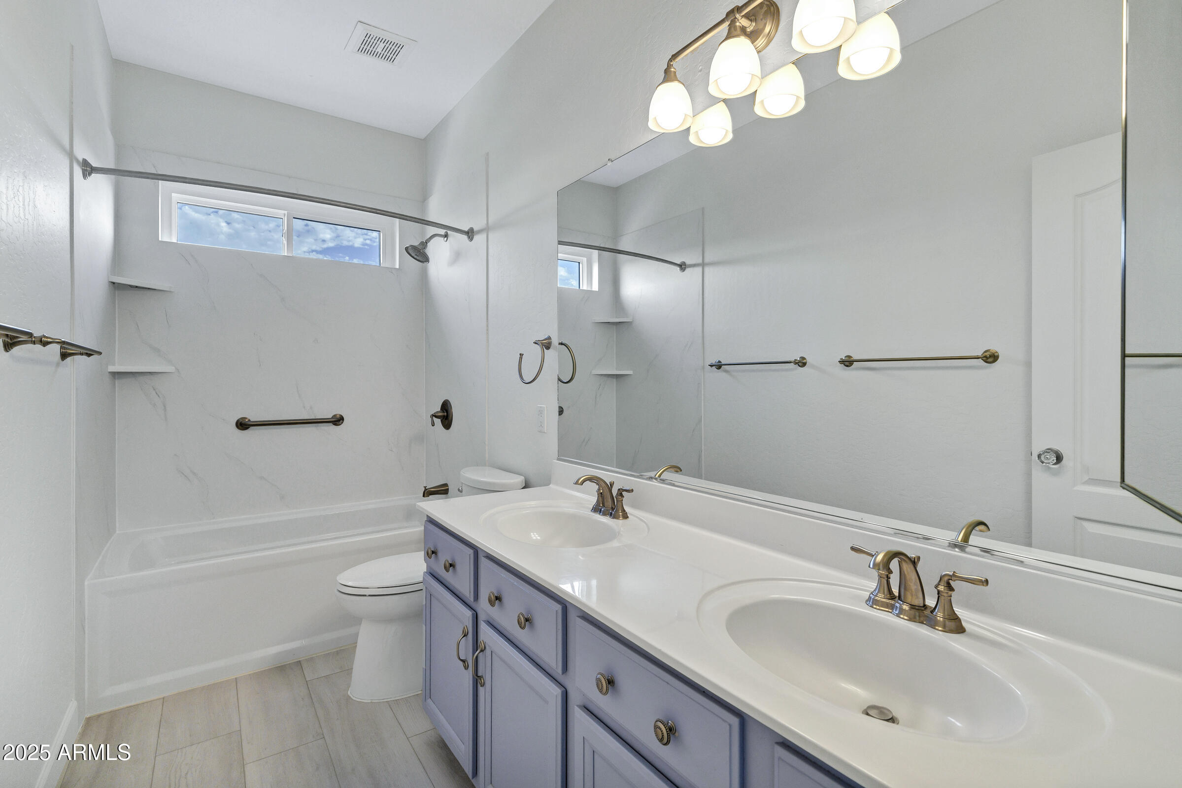 1403 West Windhaven Avenue Gilbert, AZ 85233 - Photo 28 of 64 a bathroom with a bathtub shower sink vanity and toilet