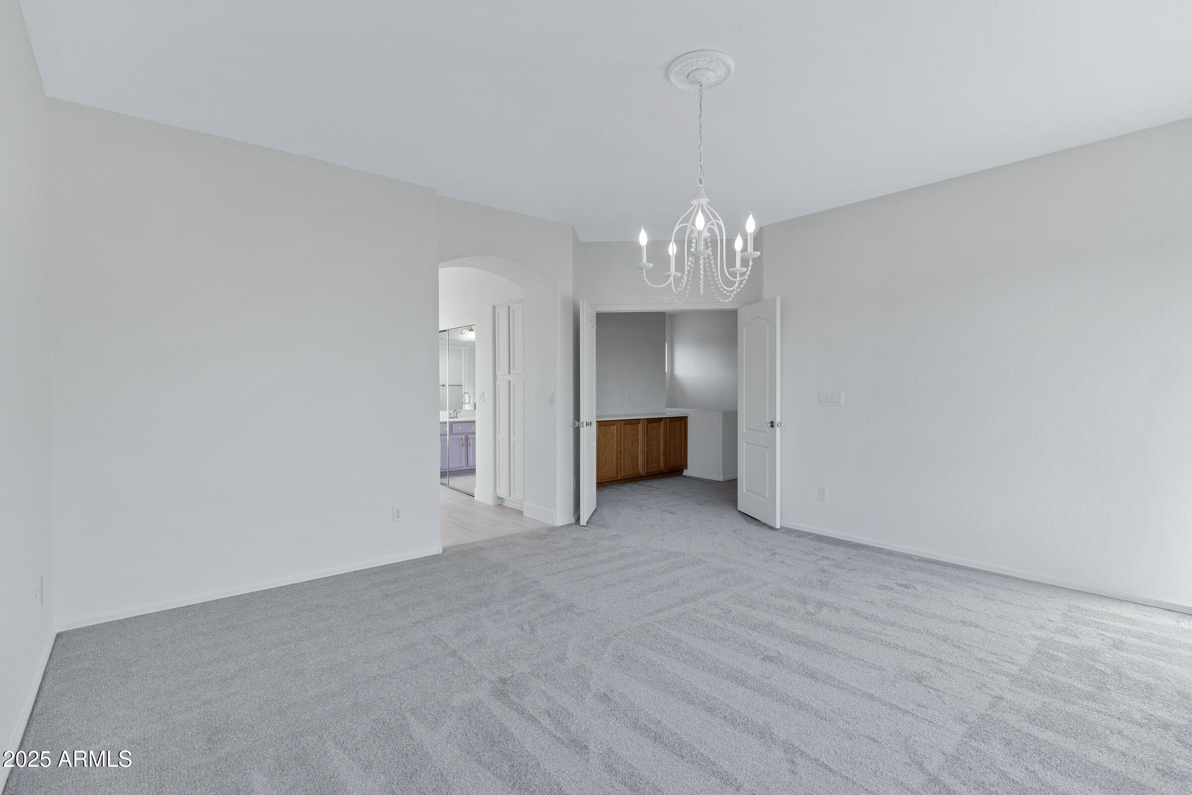 1403 West Windhaven Avenue Gilbert, AZ 85233 - Photo 31 of 64 a view of empty room with wooden floor and kitchen view