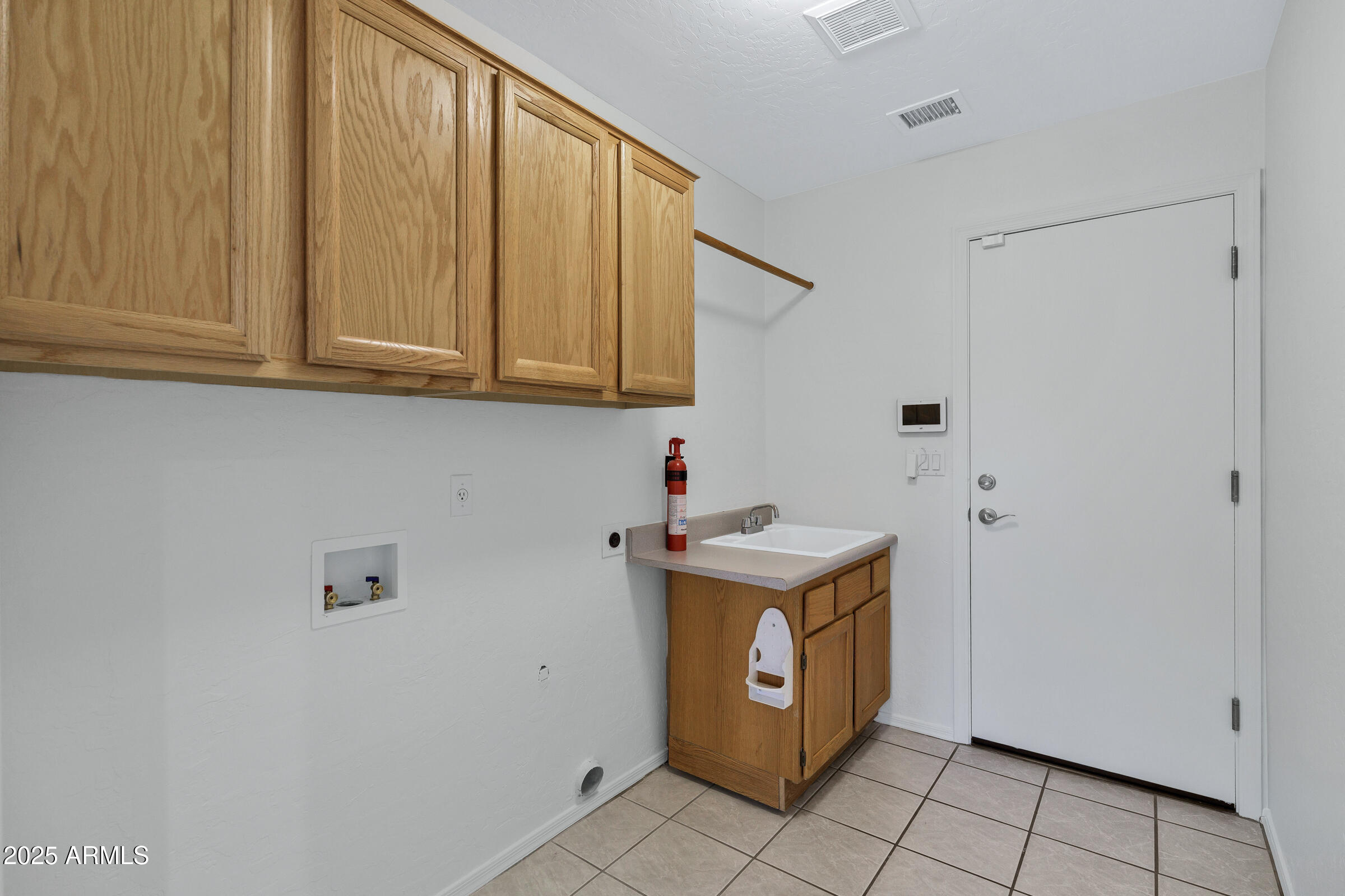 1403 West Windhaven Avenue Gilbert, AZ 85233 - Photo 35 of 64 a utility room with granite countertop a sink