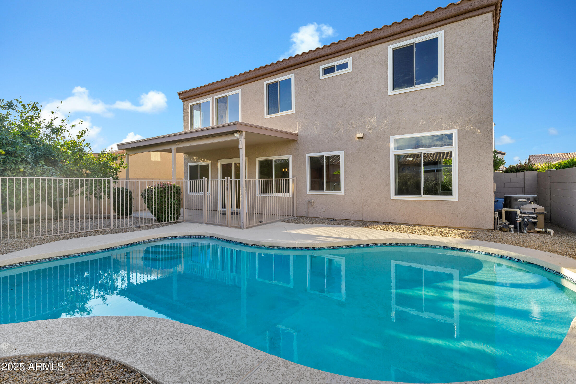 1403 West Windhaven Avenue Gilbert, AZ 85233 - Photo 37 of 64 a front view of a house with swimming pool