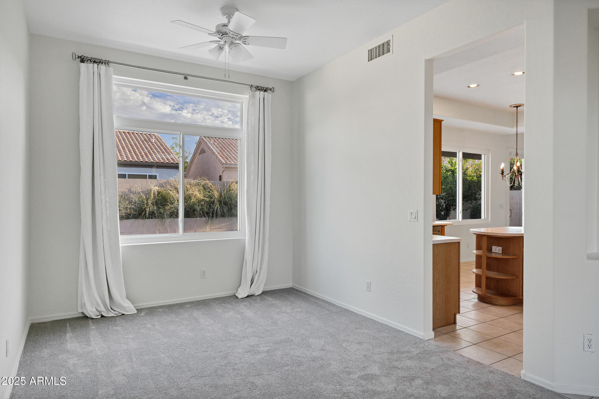 1403 West Windhaven Avenue Gilbert, AZ 85233 - Photo 10 of 64 an empty room with a fireplace and a window
