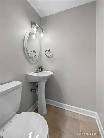 a bathroom with a sink toilet and a mirror
