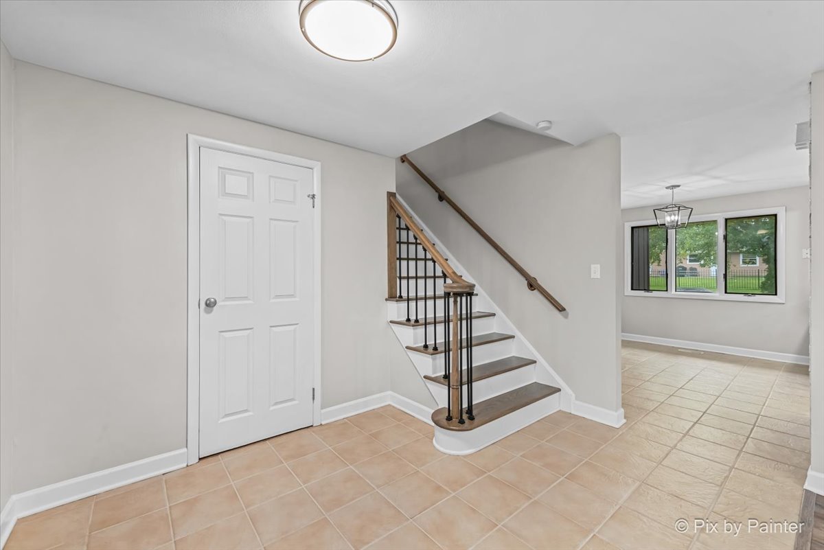 415 Laconia Court Schaumburg, IL 60193 - Photo 2 of 36 a view of entryway with wooden floor and stairs