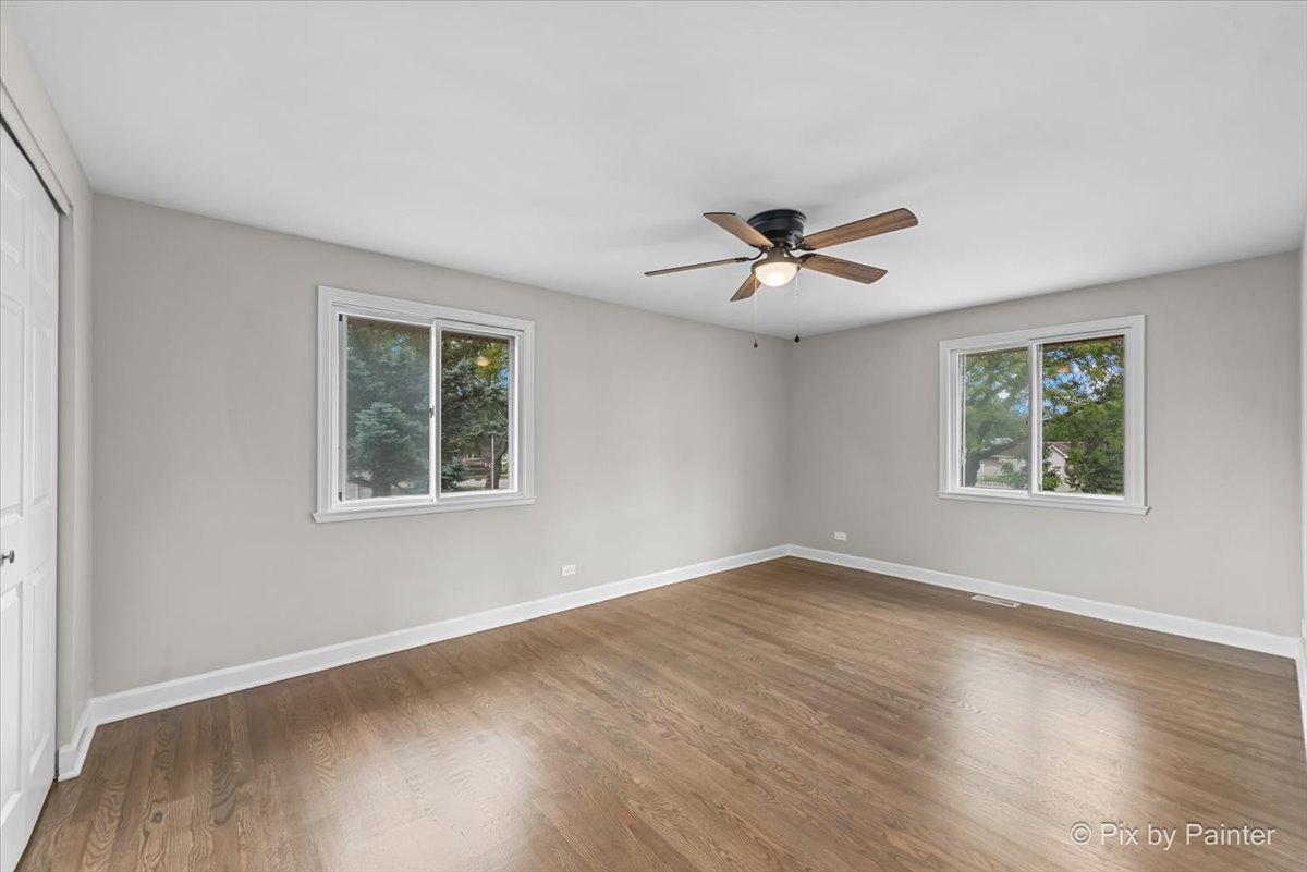 415 Laconia Court Schaumburg, IL 60193 - Photo 23 of 36 an empty room with wooden floor and windows