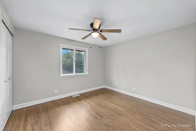 a view of a room with wooden floor and windows