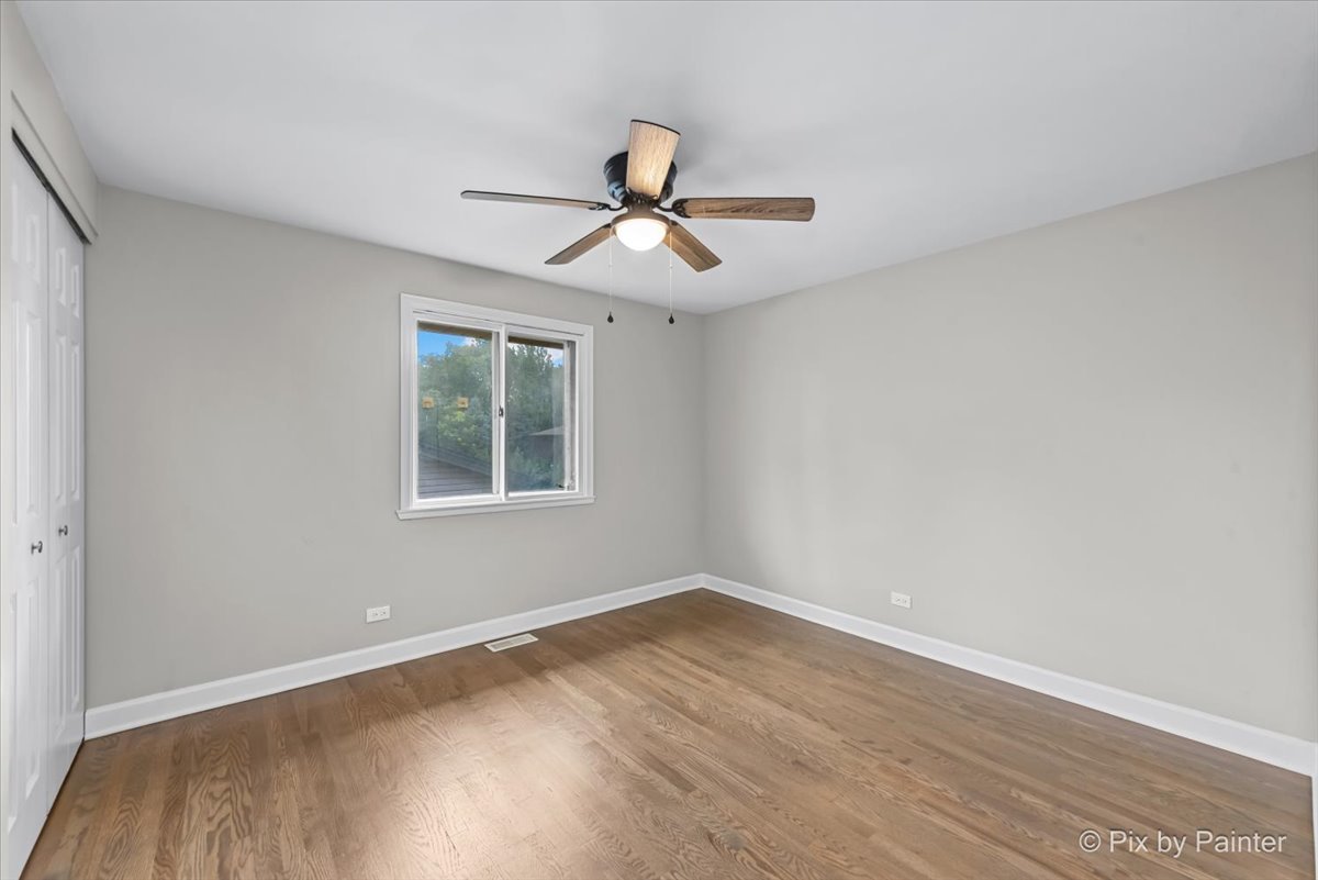 415 Laconia Court Schaumburg, IL 60193 - Photo 26 of 36 a view of a room with wooden floor and windows