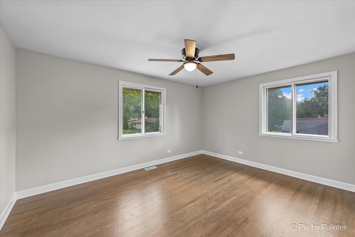 415 Laconia Court Schaumburg, IL 60193 - Photo 28 of 36 a view of a room with wooden floor and windows