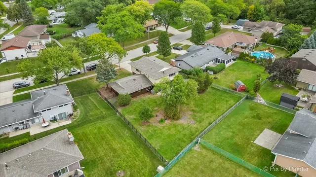 an aerial view of residential houses with outdoor space