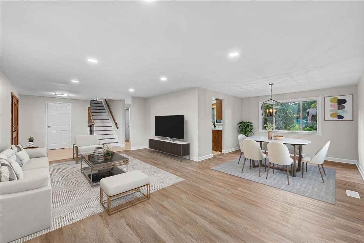 415 Laconia Court Schaumburg, IL 60193 - Photo 5 of 36 a living room with furniture a wooden floor and a flat screen tv