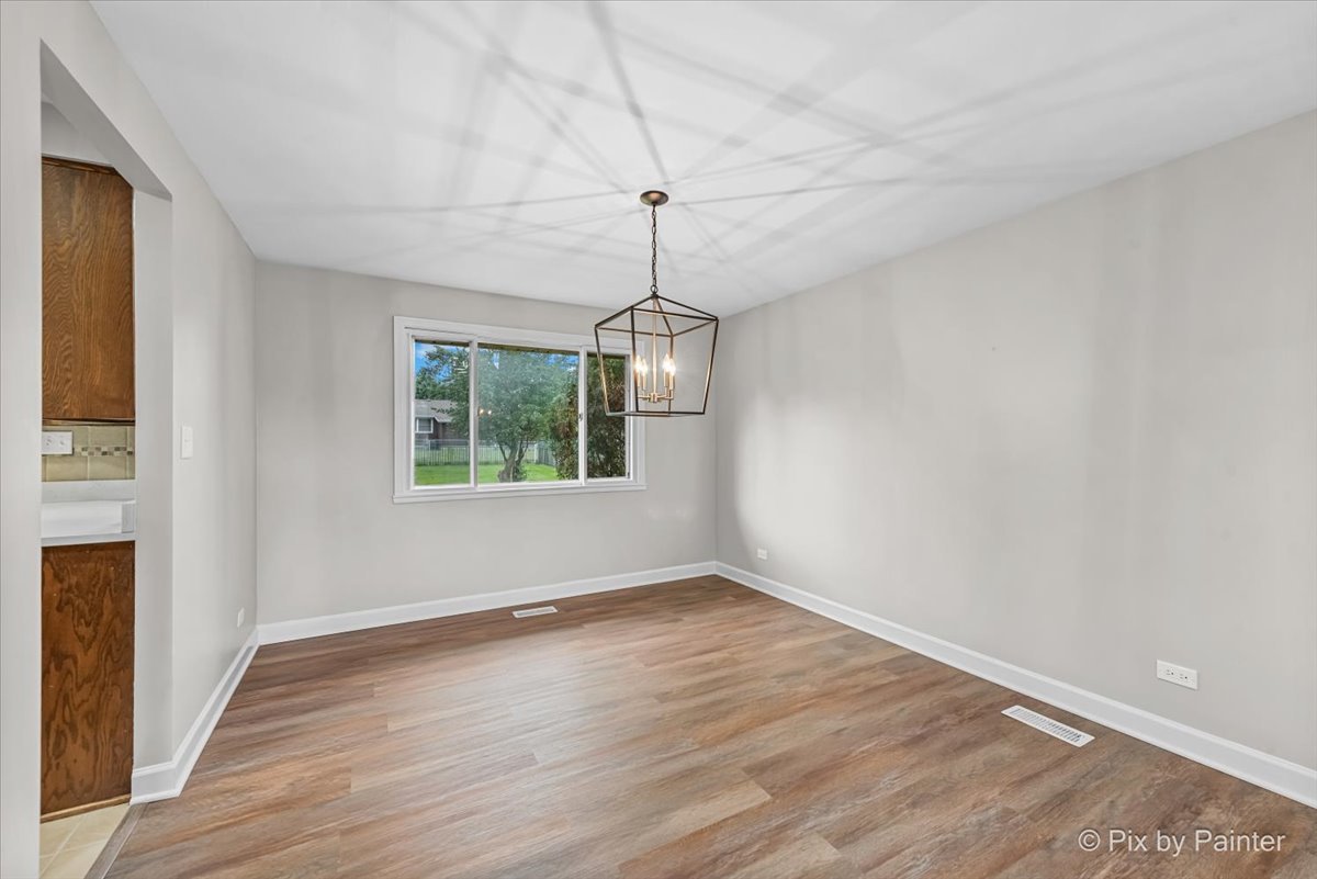 415 Laconia Court Schaumburg, IL 60193 - Photo 8 of 36 a view of empty room with wooden floor and fan