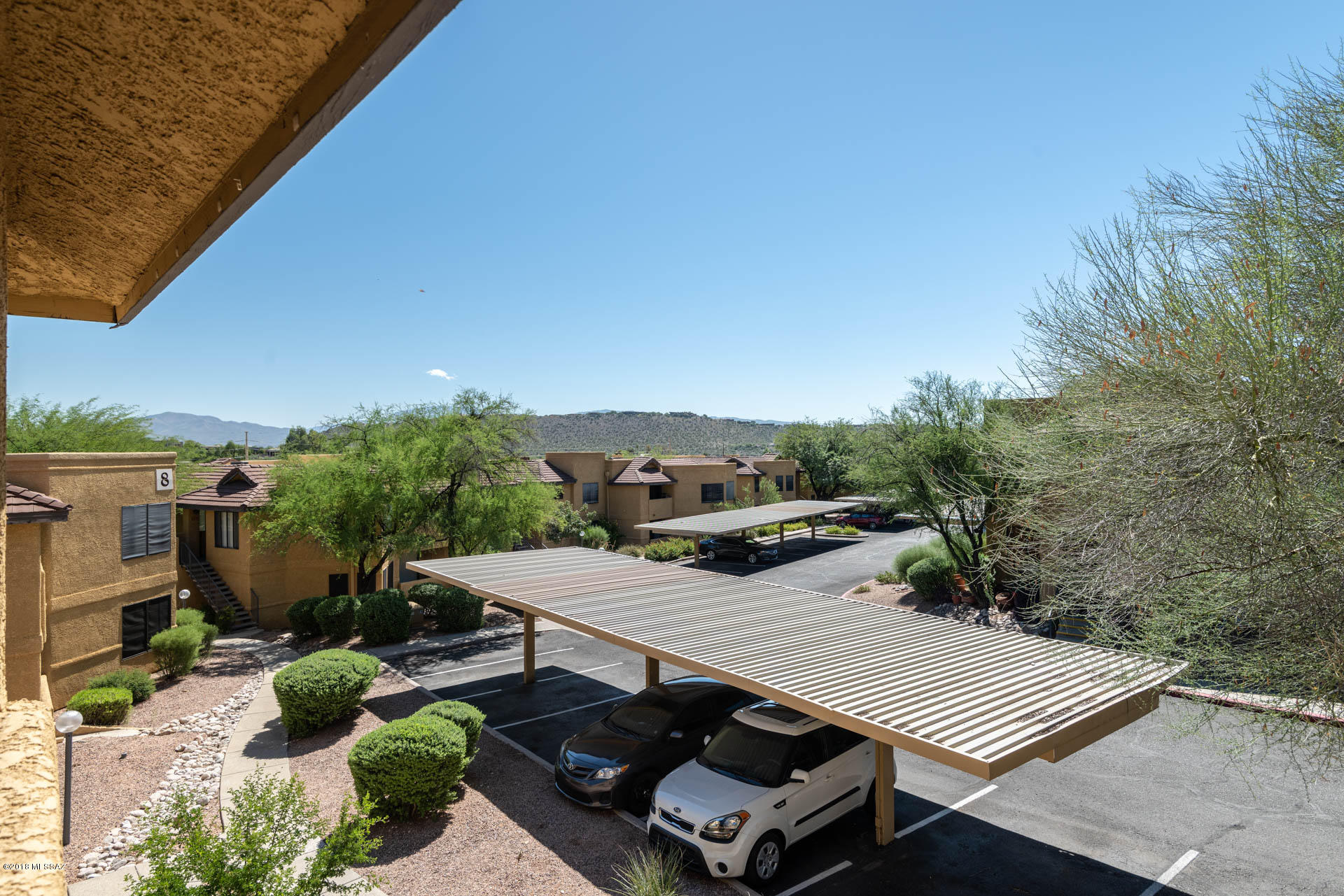 7255 East Snyder Road, Unit 8205 Tucson, AZ 85750 - Photo 4 of 23 a view of a terrace with chairs and potted plants