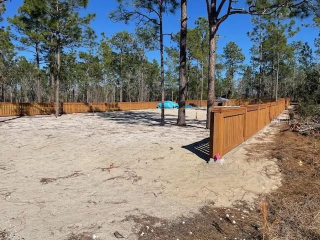 a view of a yard with trees