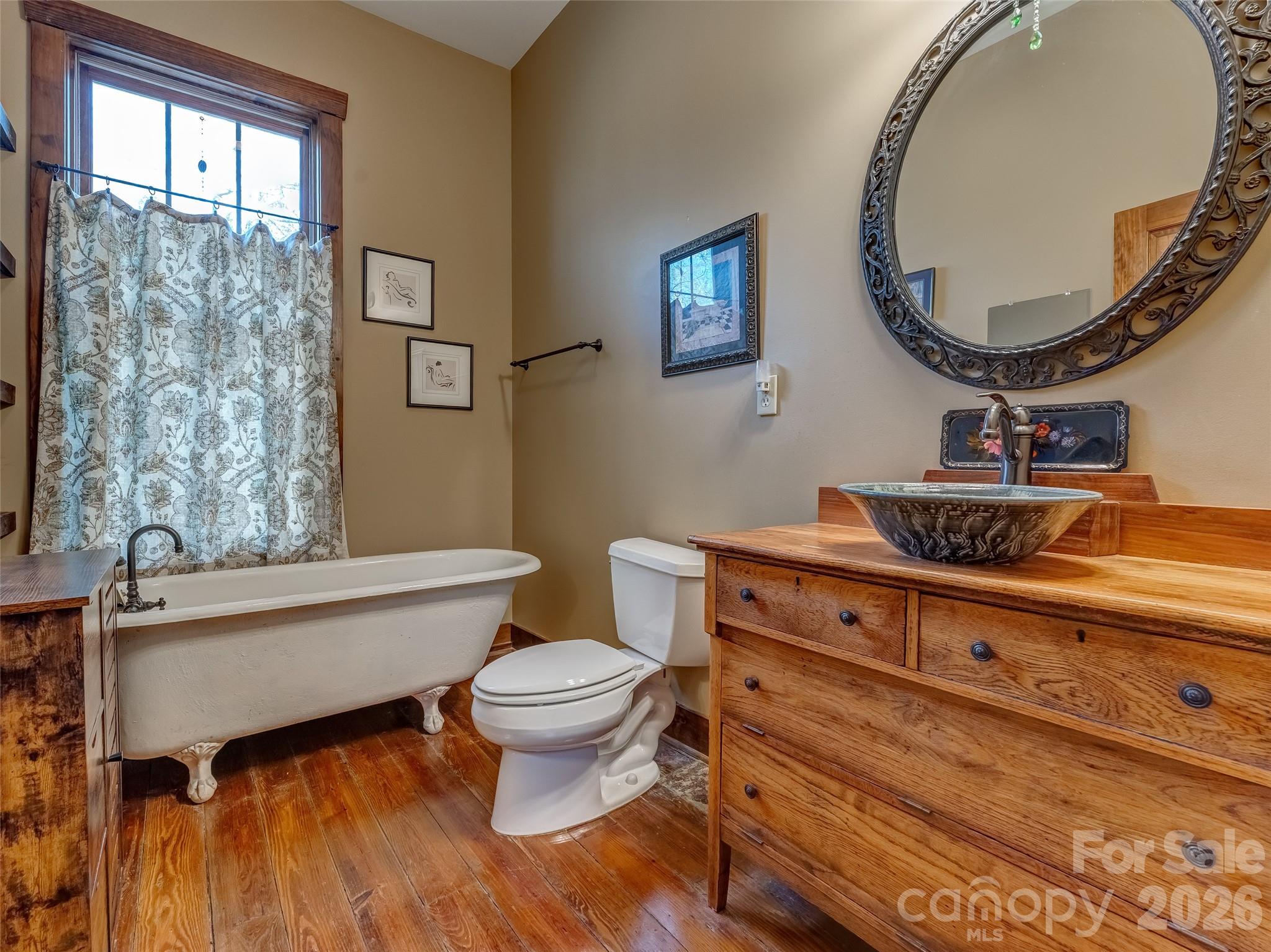 60 West Morgan Street Brevard, NC 28712 - Photo 20 of 48 a bathroom with a toilet a sink and mirror