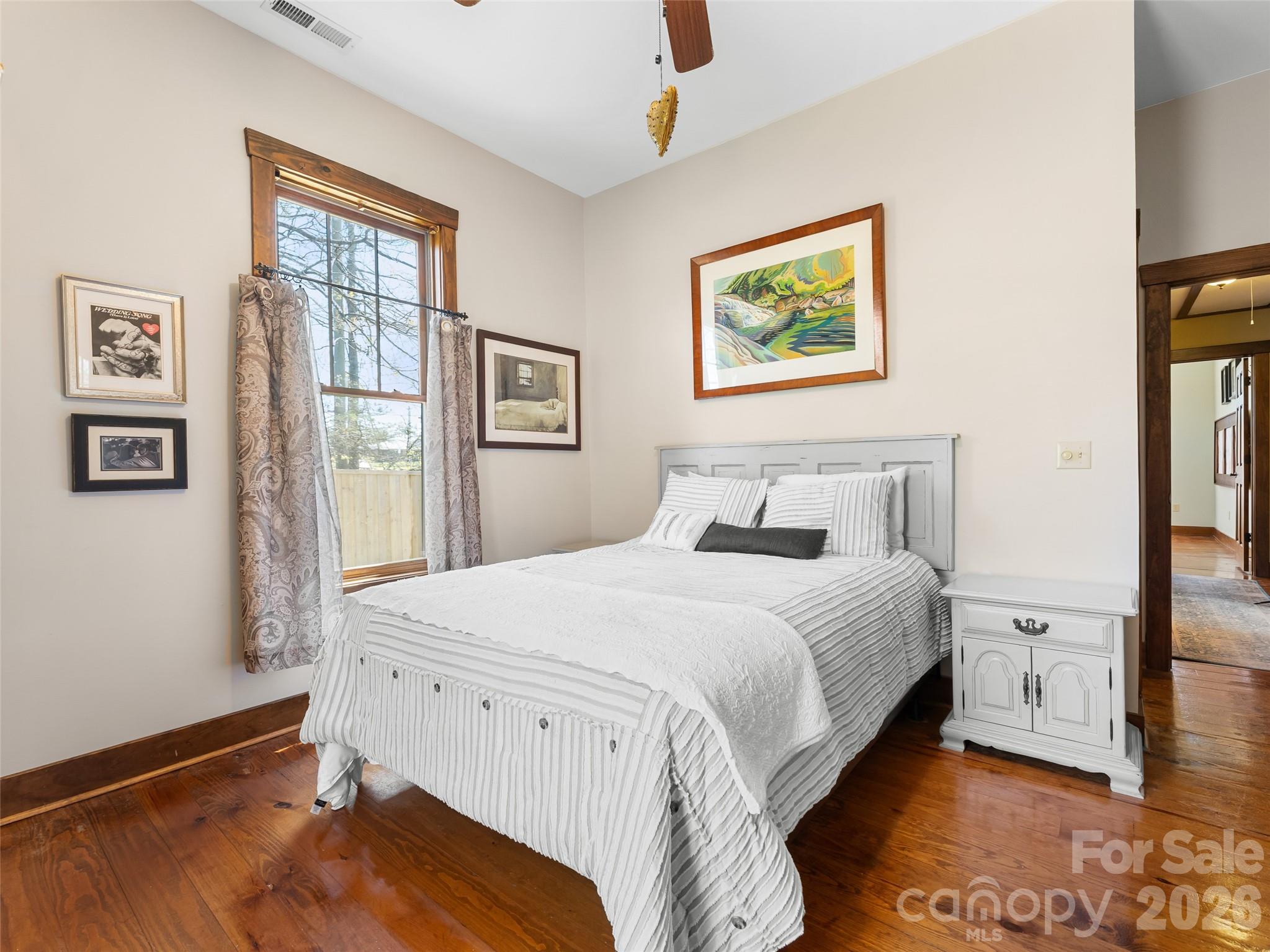 60 West Morgan Street Brevard, NC 28712 - Photo 21 of 48 a bedroom with a bed and a painting on the wall