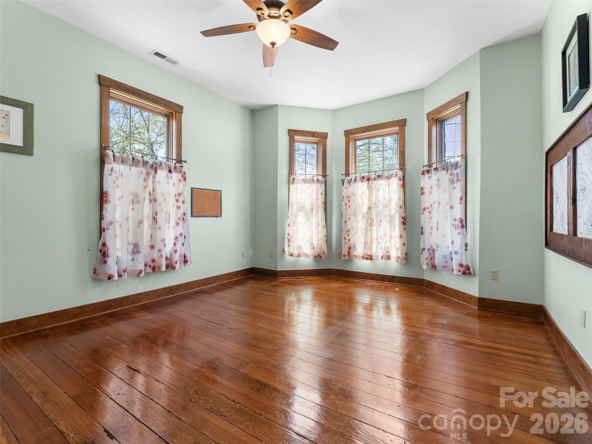 60 West Morgan Street Brevard, NC 28712 - Photo 24 of 48 a view of an empty room with wooden floor and a window