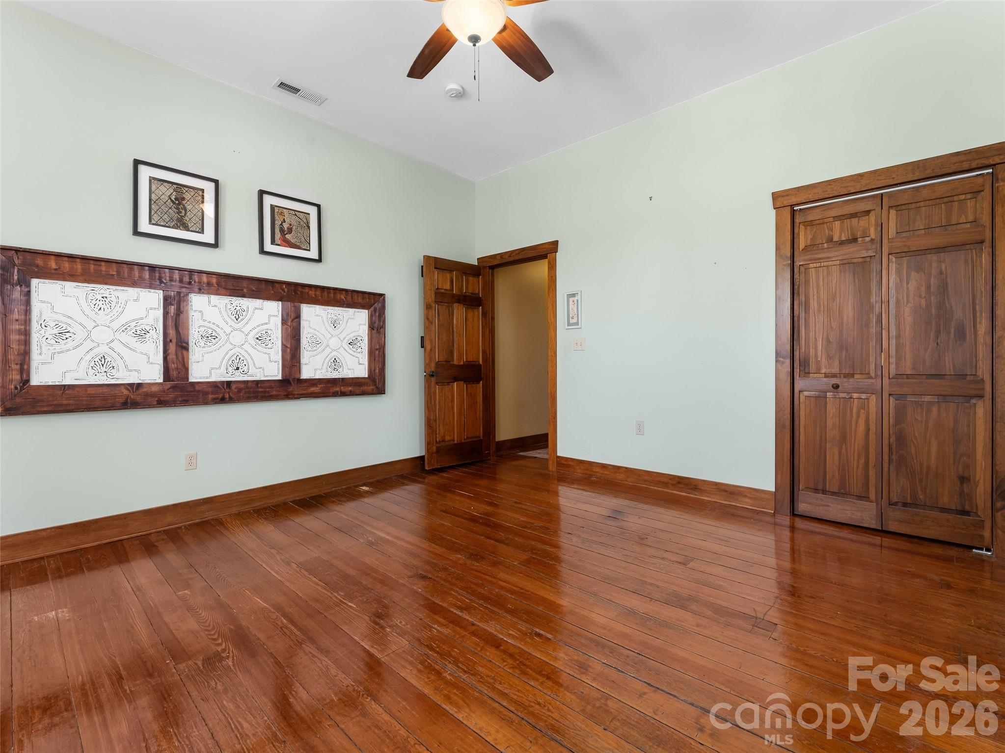 60 West Morgan Street Brevard, NC 28712 - Photo 25 of 48 a view of an empty room with wooden floor and a window