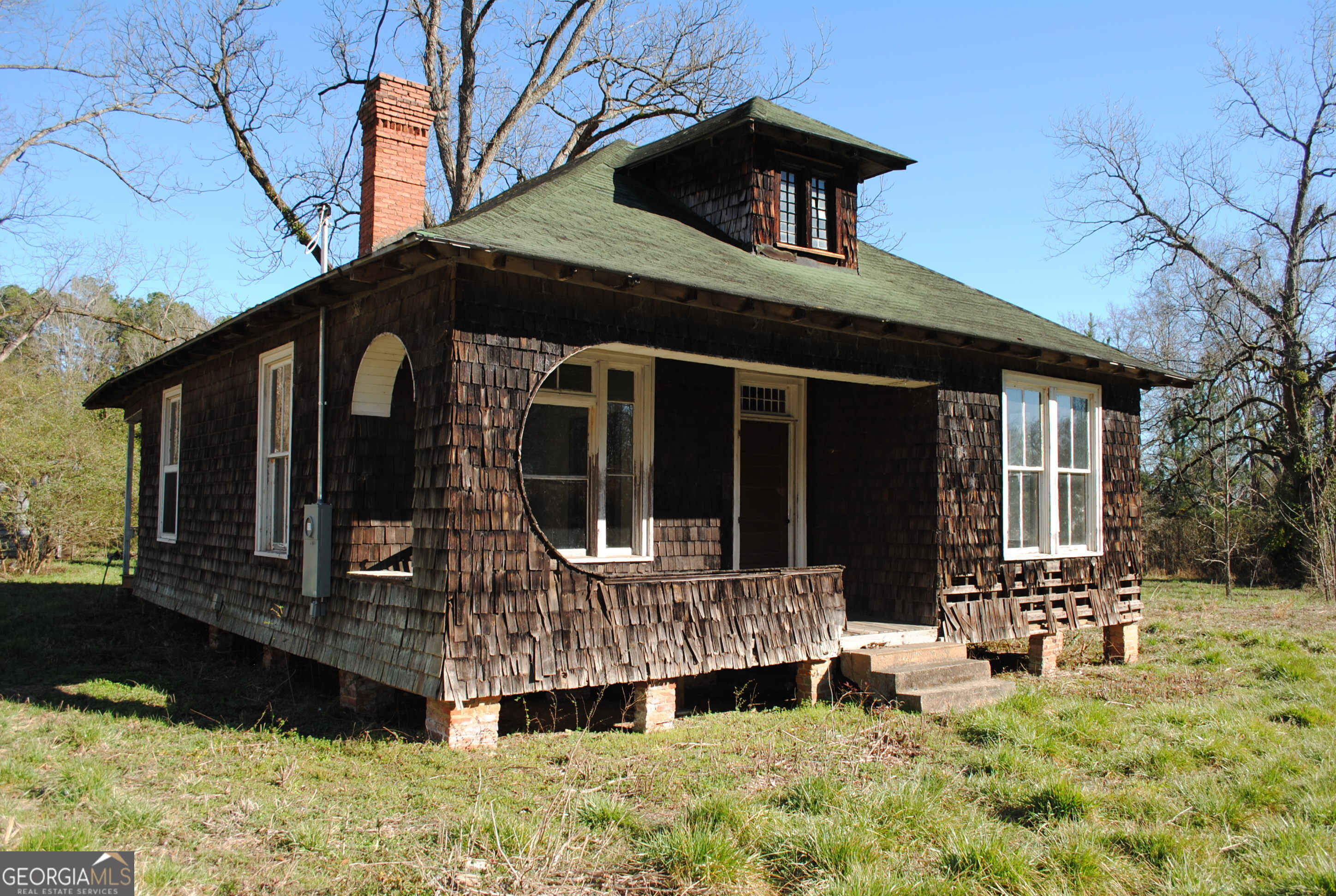 9822 Jones Street Sparta, GA 31087 - Photo 1 of 52 a front view of a house with a yard outdoor seating and garage