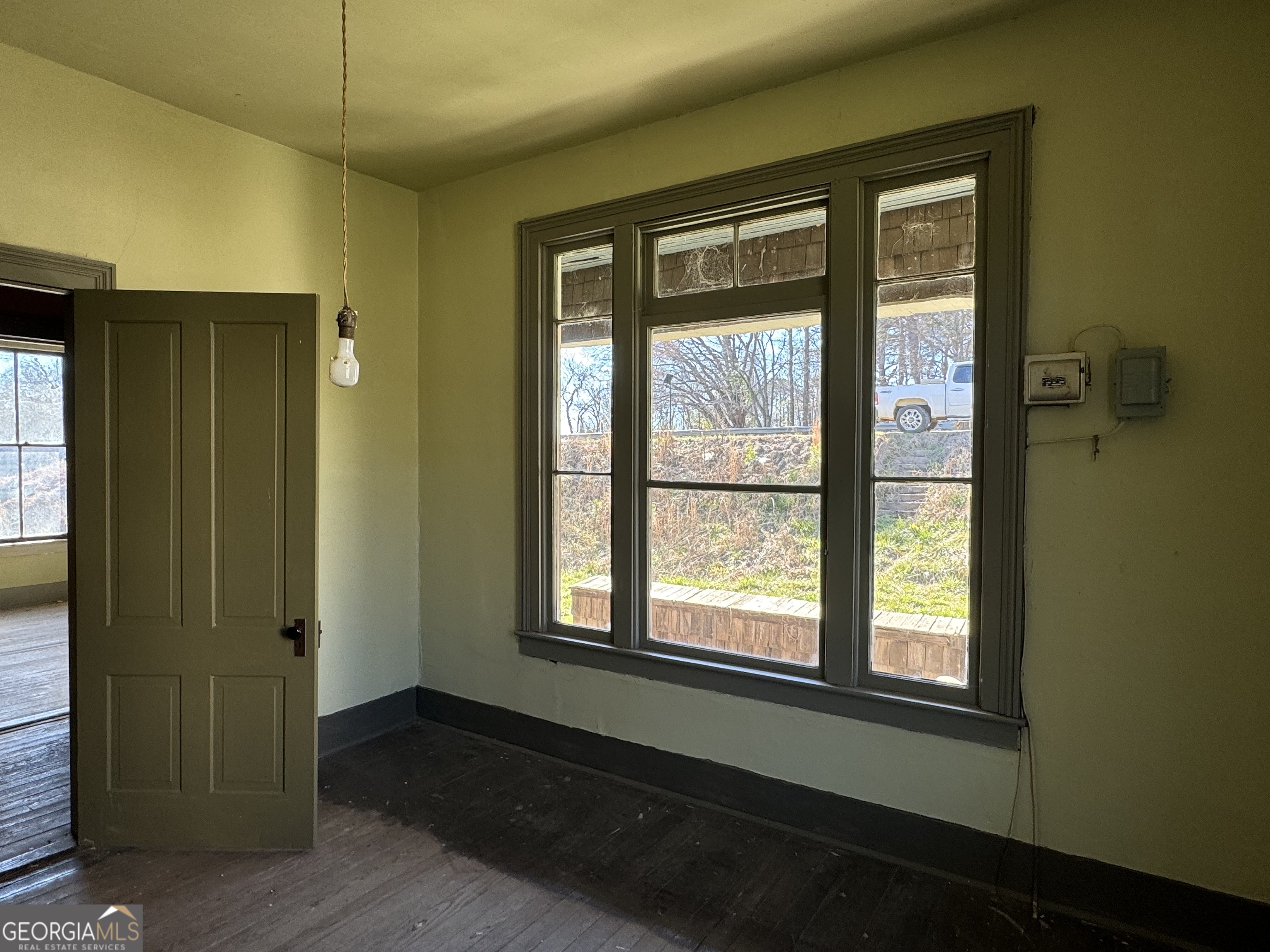 9822 Jones Street Sparta, GA 31087 - Photo 12 of 52 an empty room with large window and a hallway
