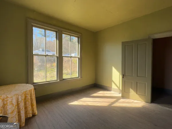 a bedroom with a bed and a mirror