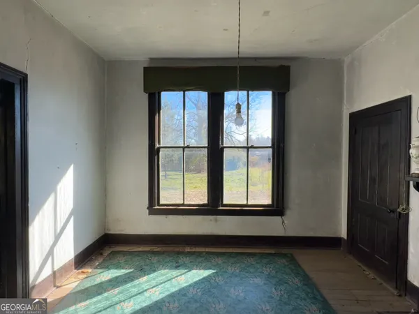 a view of kitchen with refrigerator and window