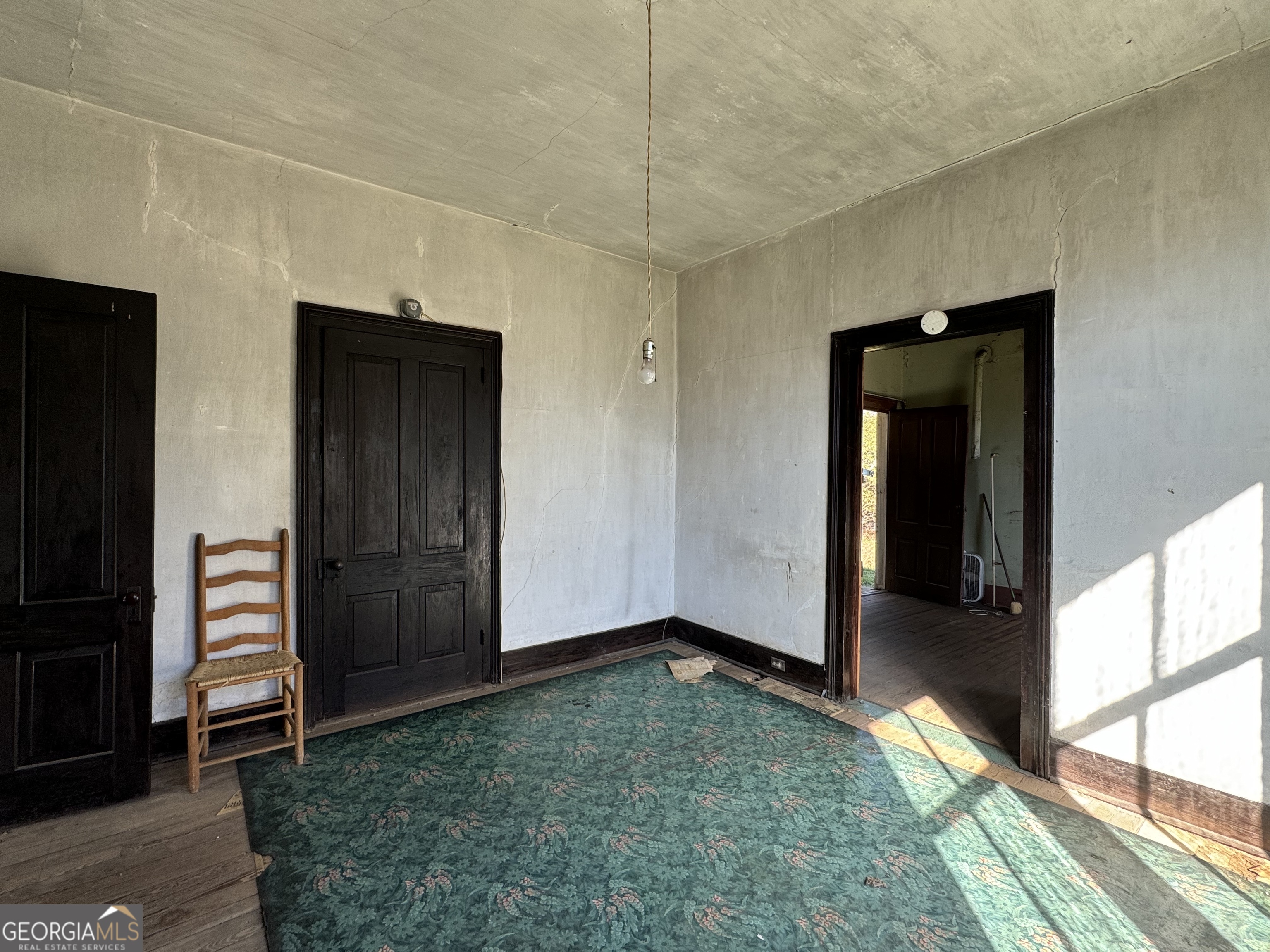 9822 Jones Street Sparta, GA 31087 - Photo 28 of 52 wooden floor and window in an empty room