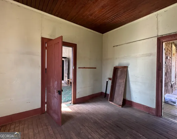 a view of a house with a window and wooden fence
