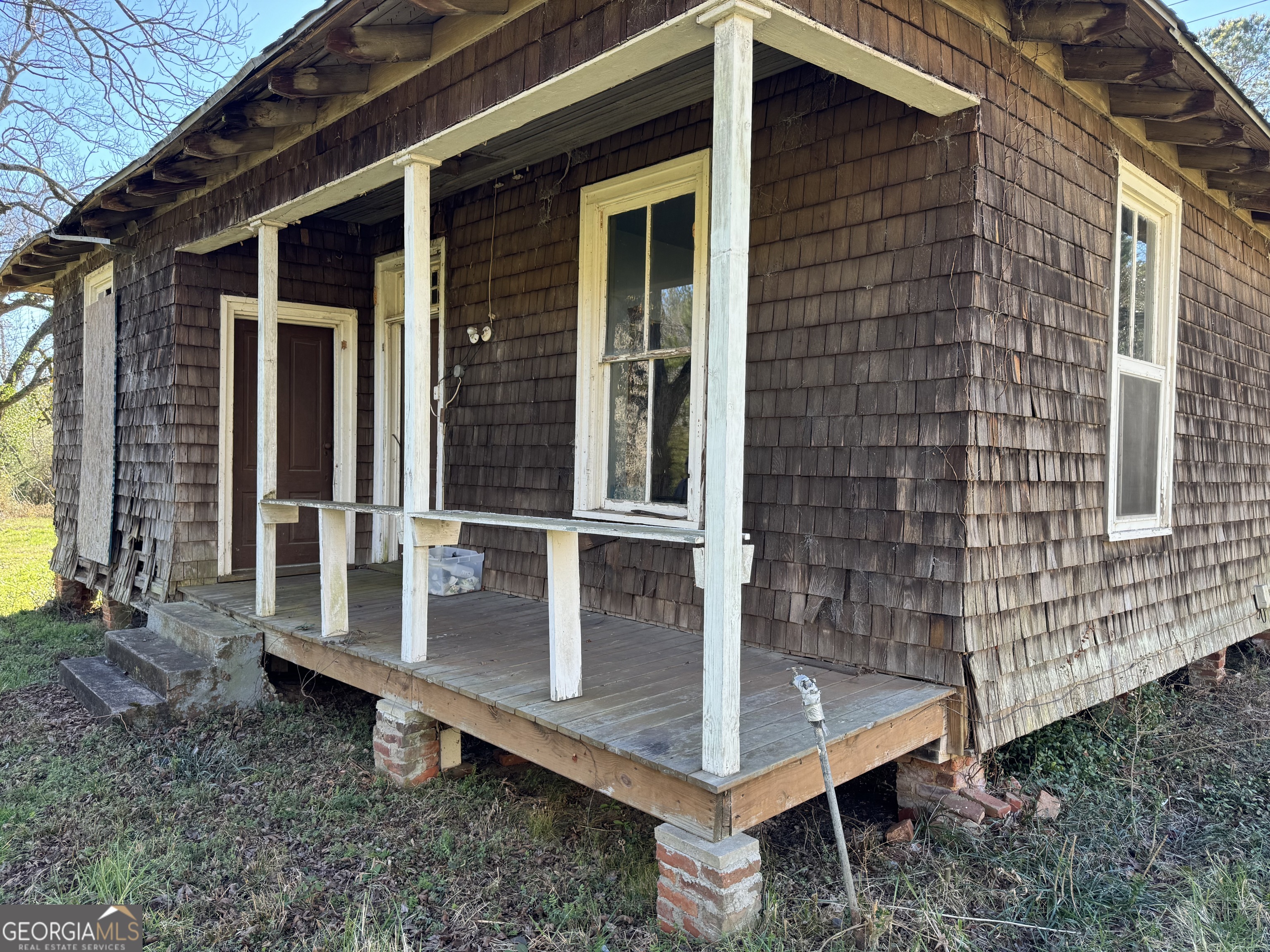 9822 Jones Street Sparta, GA 31087 - Photo 35 of 52 a view of a house with a window and wooden fence