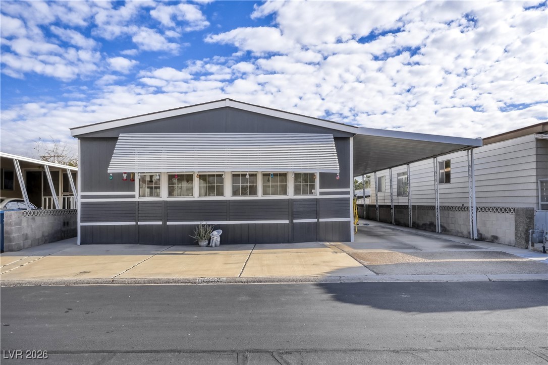 4552 Royal Ridge Avenue Las Vegas, NV 89103 - Photo 2 of 13 Manufactured / mobile home featuring an attached carport