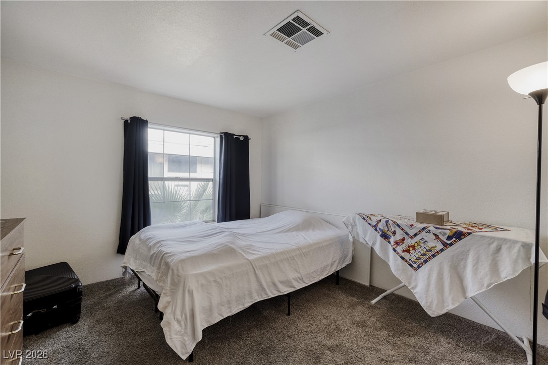 4552 Royal Ridge Avenue Las Vegas, NV 89103 - Photo 8 of 13 Bedroom featuring dark carpet