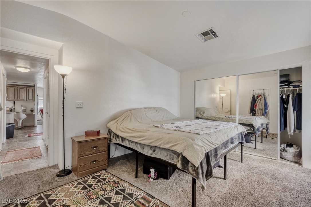4552 Royal Ridge Avenue Las Vegas, NV 89103 - Photo 9 of 13 Bedroom with a closet and light colored carpet