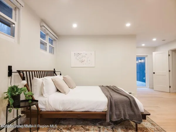 a bedroom with bed and a painting on the wall