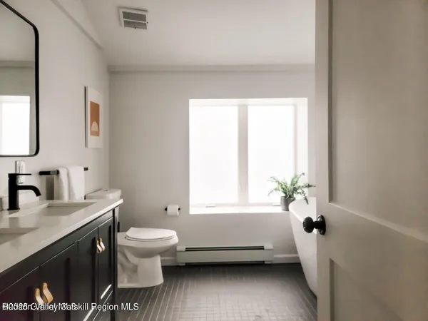 a bathroom with a granite countertop toilet a sink and a bathtub