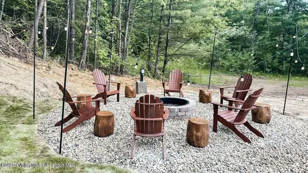 a view of a patio with chairs and potted plants