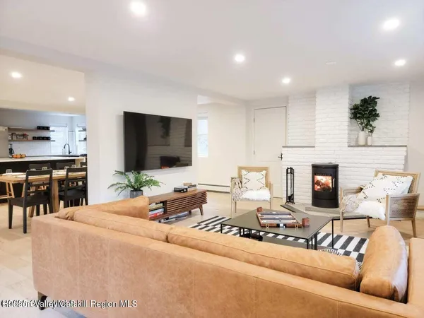 a living room with fireplace furniture and a flat screen tv