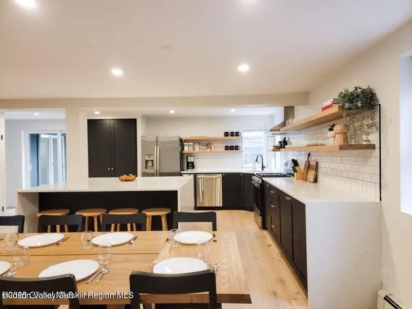 a kitchen with stainless steel appliances kitchen island granite countertop a sink and cabinets