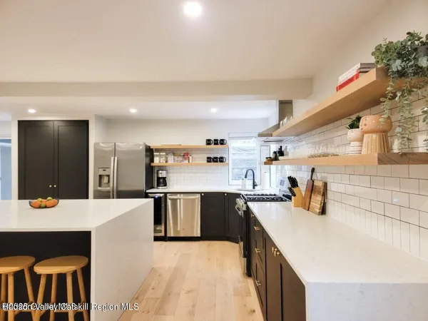 a kitchen with stainless steel appliances kitchen island granite countertop a sink and cabinets