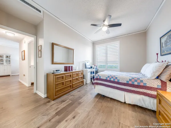 a bedroom with furniture and a mirror