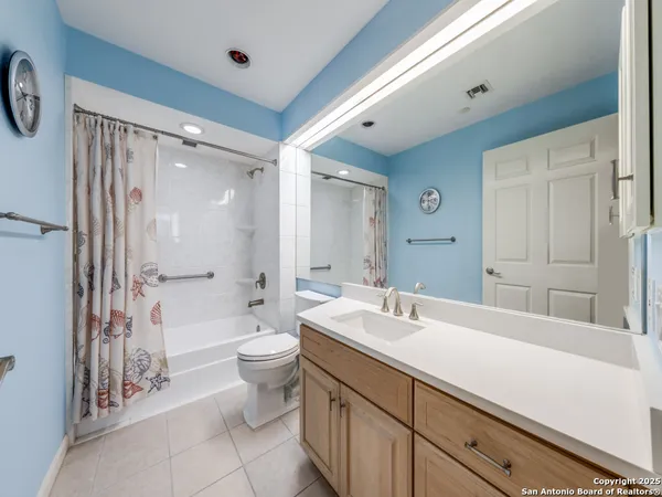 a bathroom with a double vanity sink toilet and shower