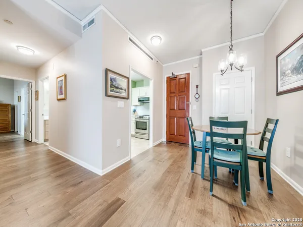 a dining room with furniture window and wooden floor