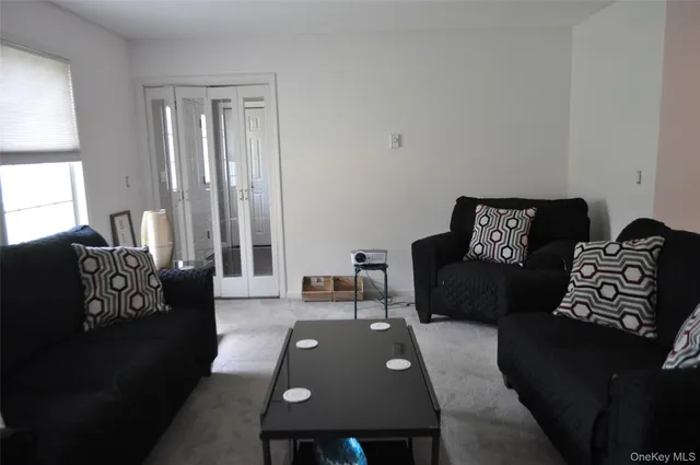 a bedroom with a bed and glass door