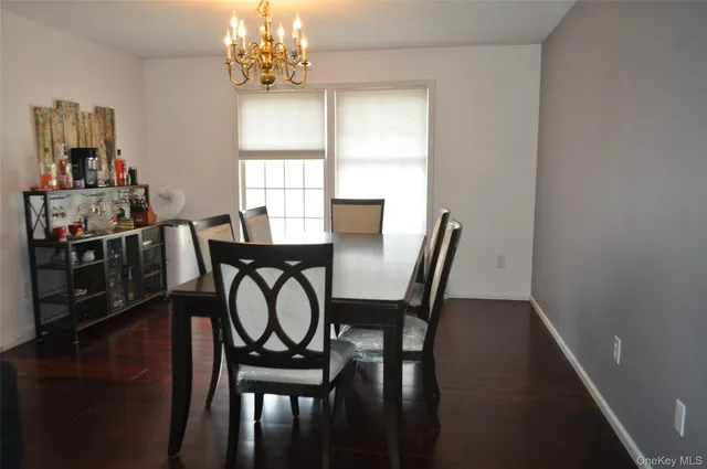 a bathroom with a tub sink shower and window