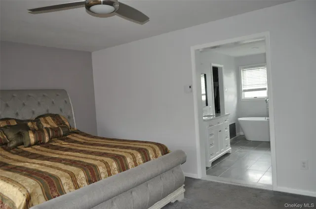 a large bed sitting in a bedroom next to a window