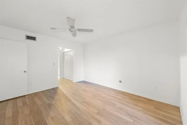 a bathroom with a toilet sink a mirror a vanity and shower
